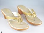 Heel type sandals for ladies in gold with center stone in floral design - 1